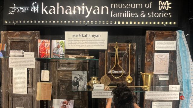 The introductory placard describing Ghar Ki Kahaniyan as a museum of families and stories, displayed above a weathered, hand-bound personal diary