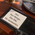 close up of the Her, Her things, Her life. My memories. plaque beside a gramophone record, at the Museo Camera, by Camerawaali